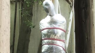 Bondaged and cocooned slave girl in the mystery garden - Full encasement fetish in zentai body bag - 11 image