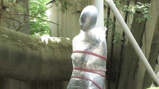 Bondaged and cocooned slave girl in the mystery garden - Full encasement fetish in zentai body bag - 13 image