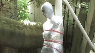 Bondaged and cocooned slave girl in the mystery garden - Full encasement fetish in zentai body bag - 14 image