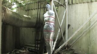 Bondaged and cocooned slave girl in the mystery garden - Full encasement fetish in zentai body bag - 3 image
