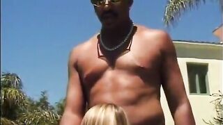 A long-haired blonde with nice tits sucks a black dude's fat cock by the pool - 9 image