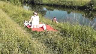 Nudist beach. Public nudity. Sexy MILF without panties and bra sunbathes naked is not shy about fisherman. Naked in public. Milf - 11 image
