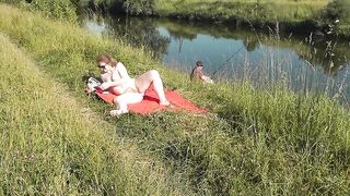 Nudist beach. Public nudity. Sexy MILF without panties and bra sunbathes naked is not shy about fisherman. Naked in public. Milf - 12 image