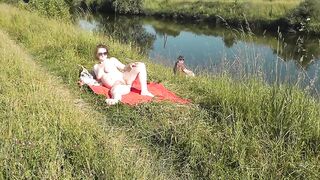 Nudist beach. Public nudity. Sexy MILF without panties and bra sunbathes naked is not shy about fisherman. Naked in public. Milf - 14 image