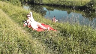 Nudist beach. Public nudity. Sexy MILF without panties and bra sunbathes naked is not shy about fisherman. Naked in public. Milf - 6 image