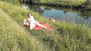 Nudist beach. Public nudity. Sexy MILF without panties and bra sunbathes naked is not shy about fisherman. Naked in public. Milf - 7 image