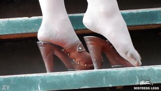 Beautiful feet in tights and clogs outdoor - 4 image