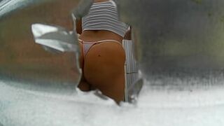 Woman recorded in outdoor booth (LATINA IN PUBLIC) - 1 image