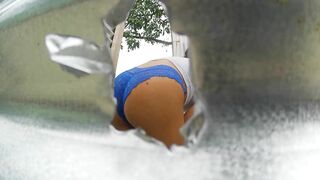 Woman recorded in outdoor booth (LATINA IN PUBLIC)