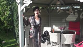 Garden, beautiful sunny day. Wanilianna in transparent raincoat, black seamed nylons - 6 image