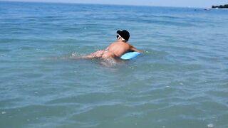I spied on a nudist beach how a naked girl with big tits floats and sunbathes, naked in public - 4 image