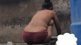 Desi Indian village bathroom in open courtyard wearing red tights bathing