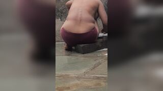 Desi Indian village bathroom in open courtyard wearing red tights bathing - 11 image