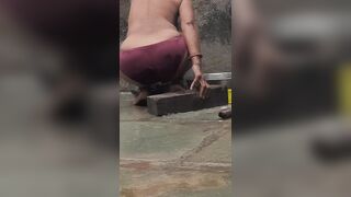 Desi Indian village bathroom in open courtyard wearing red tights bathing - 14 image