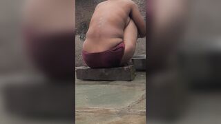 Desi Indian village bathroom in open courtyard wearing red tights bathing - 15 image