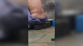 Desi Indian village bathroom in open courtyard wearing red tights bathing - 2 image