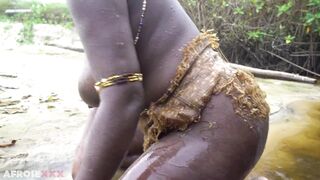 Busty African village wife making medecins outdoor in the forrest - 2 image