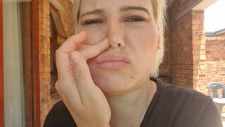 Close up view of pale blonde picking, blowing her nose, snot play - 1 image