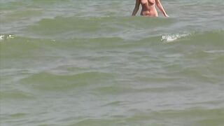Hot German blonde rubbing her moist pussy on the beach - 1 image