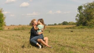 Beautiful Teen Couple in Love Passionately Kissing on the field - 1 image
